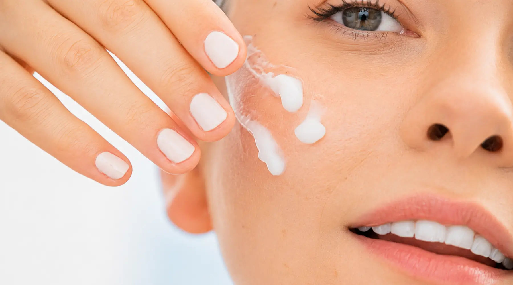 Woman applying moisturizer to support healthy skin barrier