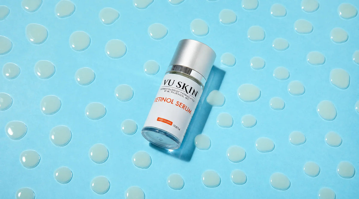 VU Retinol Serum bottle on a turquoise background with water droplets.